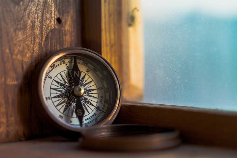 vintage compass near a window