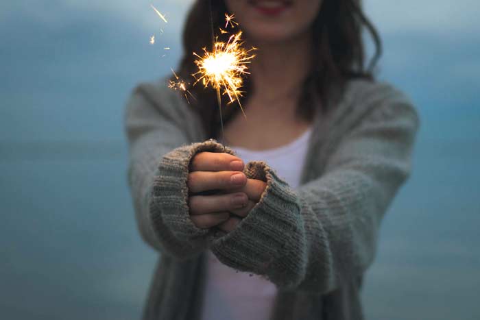 woman holding a sparkler